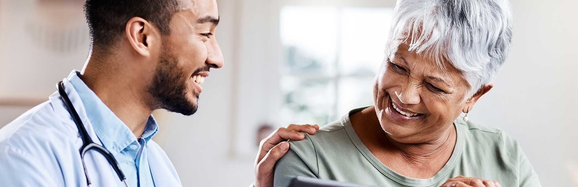 Shot of a young doctor sharing information from his digital tablet with an older patient.