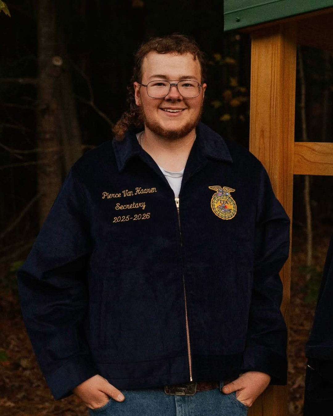Pierce VanHaaren, scholarship recipient, standing with hands in pockets, wearing his FFA jacket that says "Secretary".