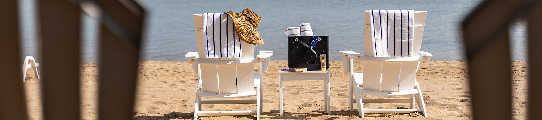 Wide shot of two chairs set up on the beach of Lake Michigan.