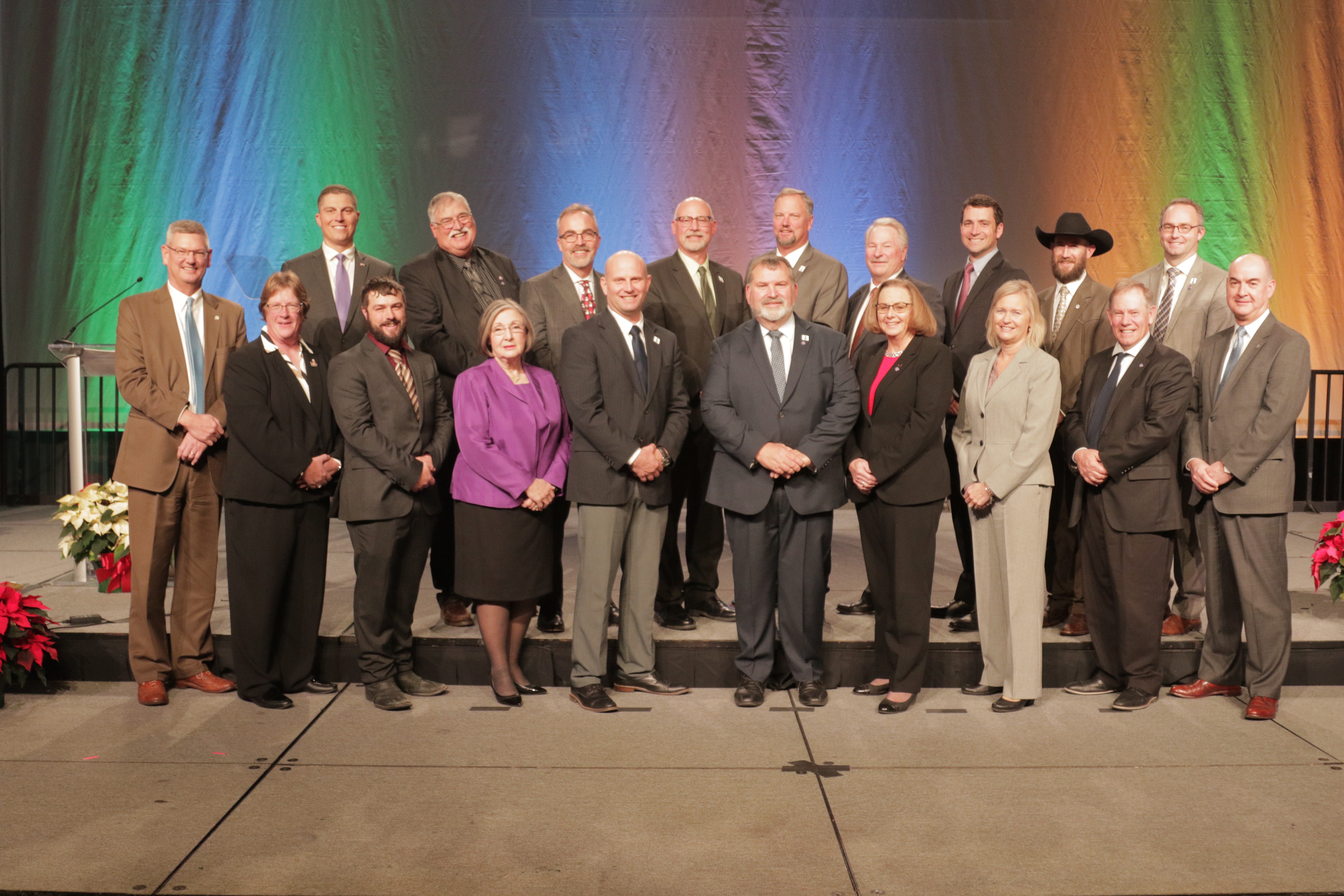 The 2022-23 MFB Board posing for a photo against a colorful backdrop at the 2022 Michigan Farm Bureau State Annual Meeting.