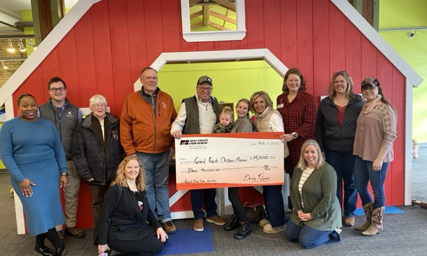 Kent County Farm Bureau Board of Directors and members present a sponsorship check to the Grand Rapids Children's Museum.