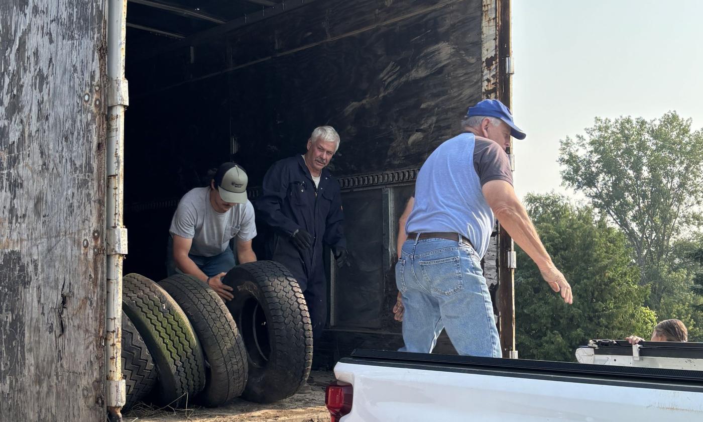 Farm Bureau members and Wilbur-Ellis intern work the tire recycling event.