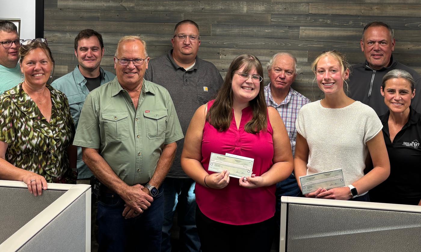 The Kent County Farm Bureau Board of Directors present Genevieve Calhoun and Anna Richmond with 2025 scholarships.