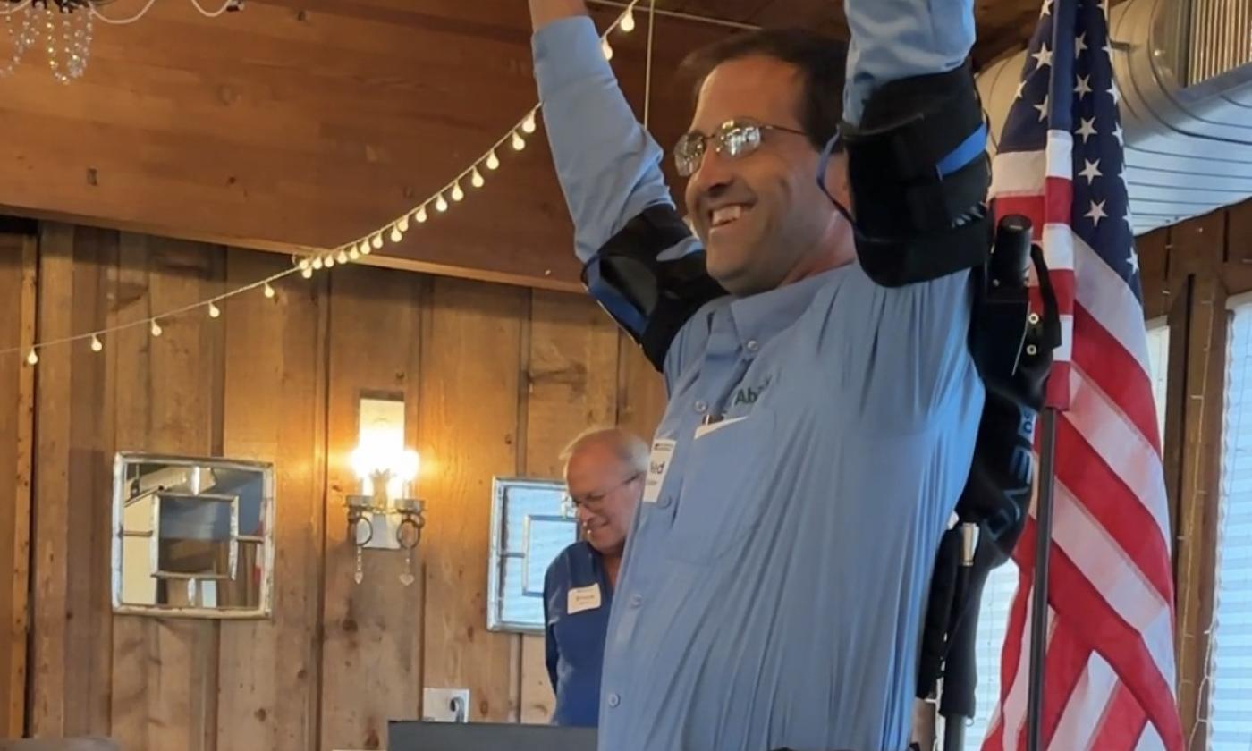 Ned Stoller of Michigan AgrAbility demonstrates a piece of high-tech adaptive equipment.