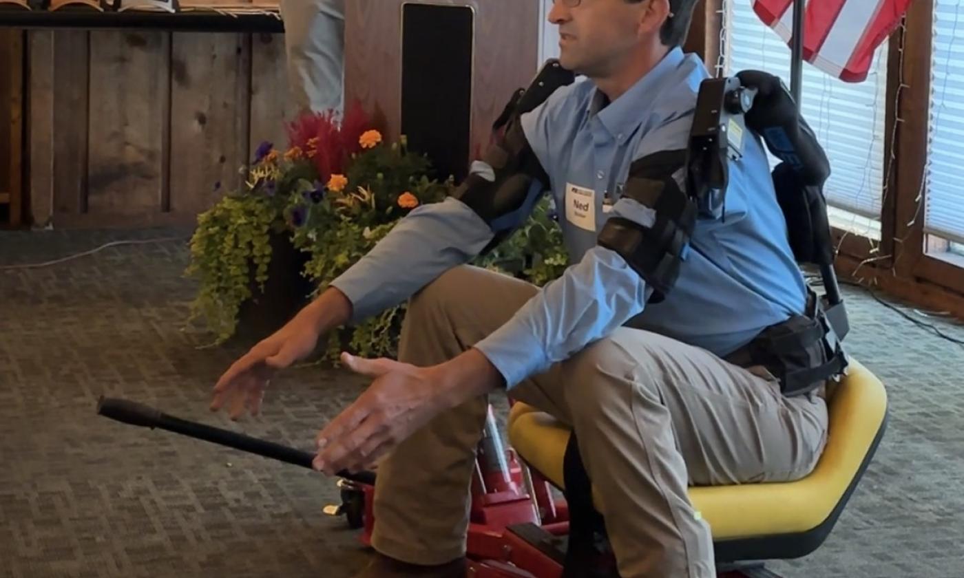 Ned Stoller of Michigan AgrAbility demonstrates a piece of adaptive equipment he created.