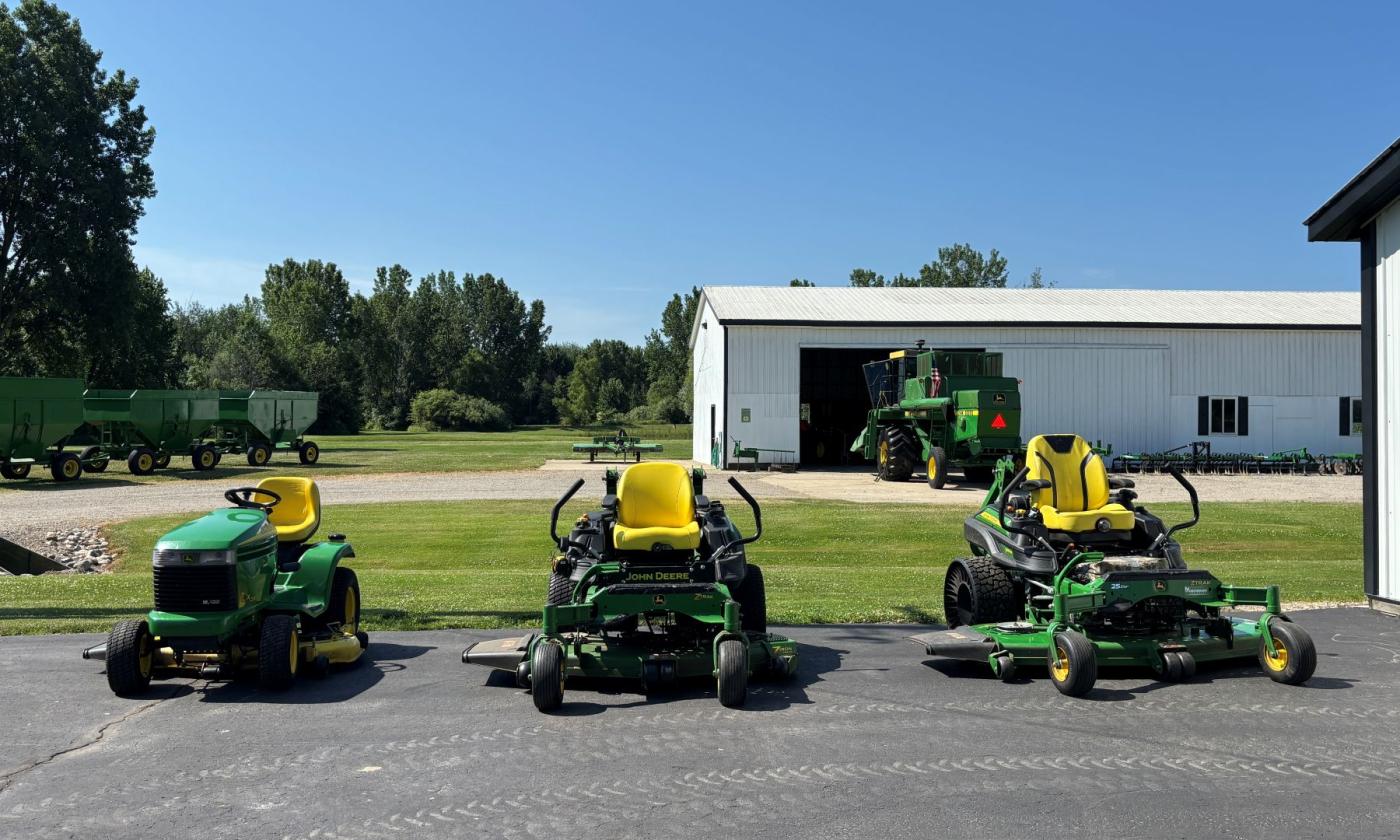 Three riding mowers.