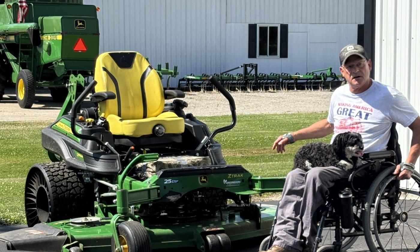 Doug VerHoeven demonstrating his adapted riding mower.