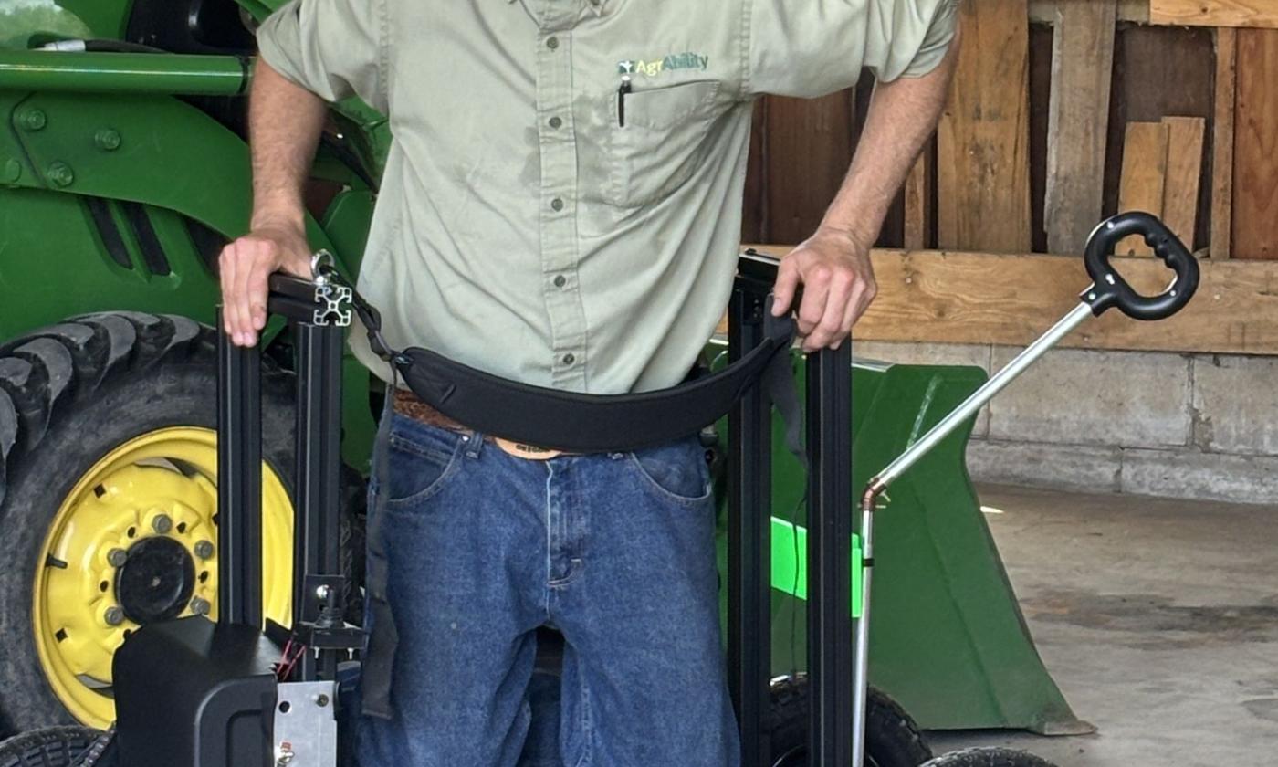 Michigan AgrAbility's Ned Stoller demonstrates a piece of adaptive equipment.