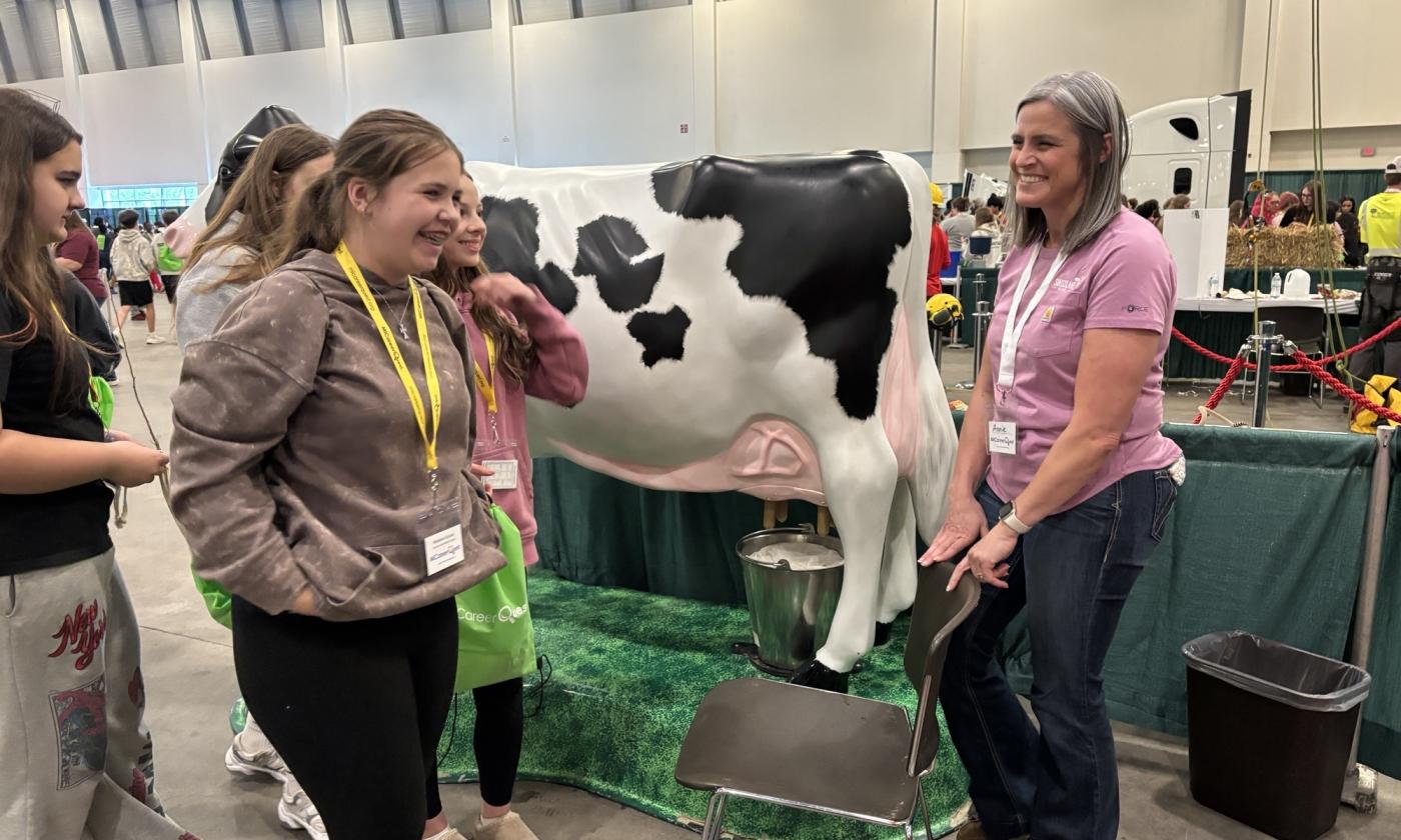 Annie Link talks with a group at MiCareer Quest at the Picture Yourself in Agriculture booth.