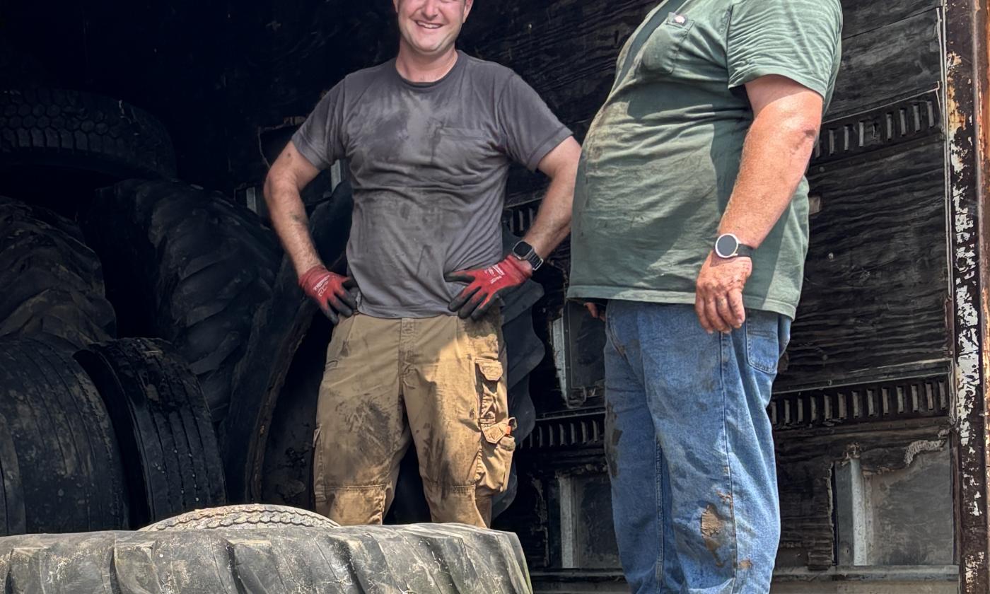 Board members loading tires at the tire recycling event.