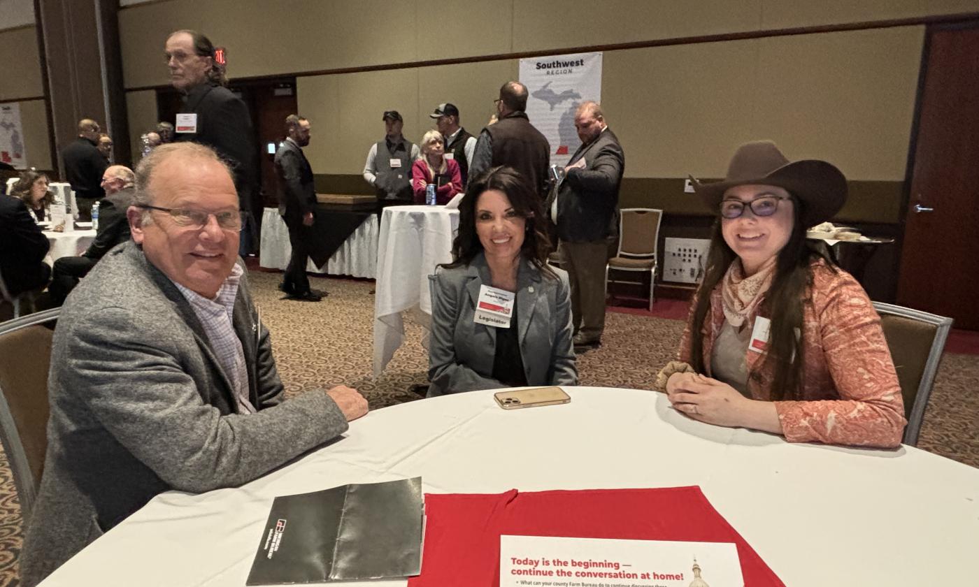 Board members Bruce Klamer and Nicole Zaagman talk with Rep. Angela Rigas at a Lansing Legislative Seminar.