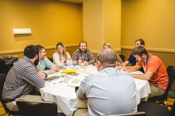 A group of young farmers sitting around a round table in a conference room at the Young Farmer Leaders Conference.