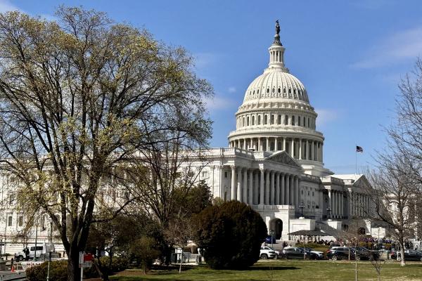 Wide shot of the U.S. Capitol Building under a clear blue sky in Washington, D.C.