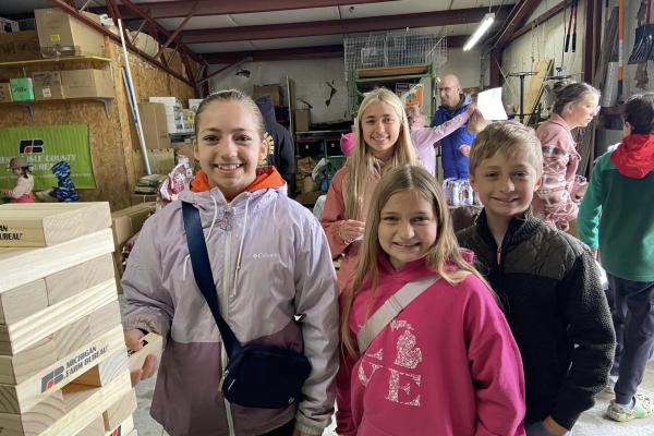 Four children playing Jenga