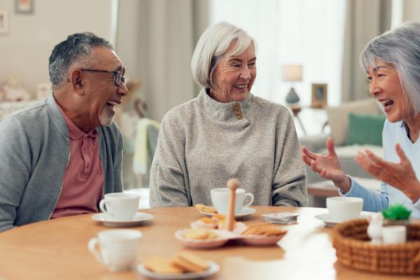 Seniors laughing over coffee