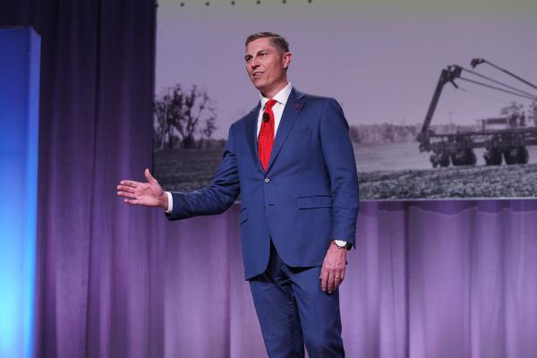 MFB President Ben LaCross gesturing with his hand while delivering the President's Address on stage at the 2025 MFB State Annual Meeting.