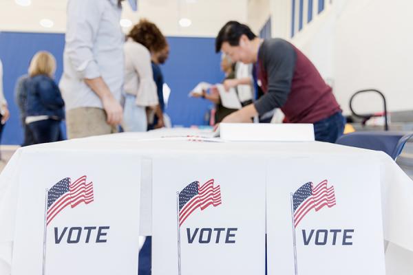 Poll workers helping voters at a table