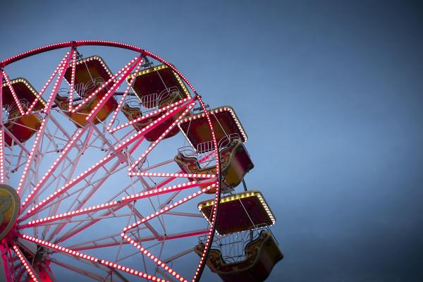 Wide shot of the top of a ferris wheel at night.