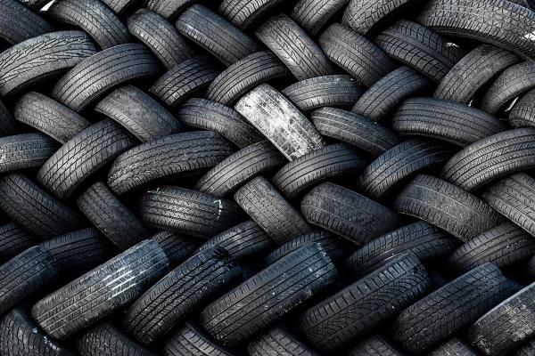 A large pile of meticulously-stacked recycled tires.