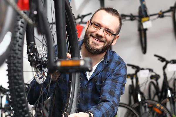 Man looking at bike at bike store.