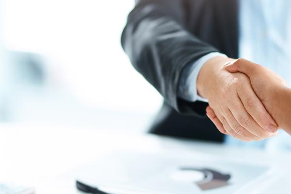 Close-up of business people shaking hands.