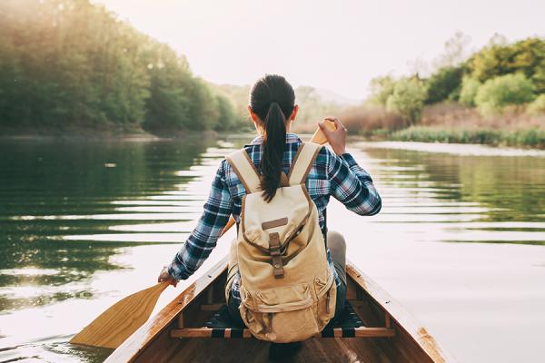 Woman canoeing on river.