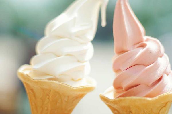 Three ice cream cones with different toppings in a row against a blue background.