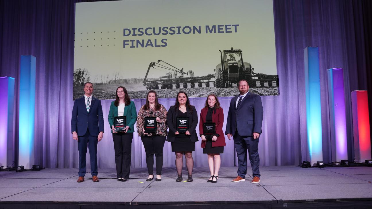Portrait of the Final Four Young Farmer Discussion Meet competitors smiling on stage at the 2025 MFB State Annual Meeting.
