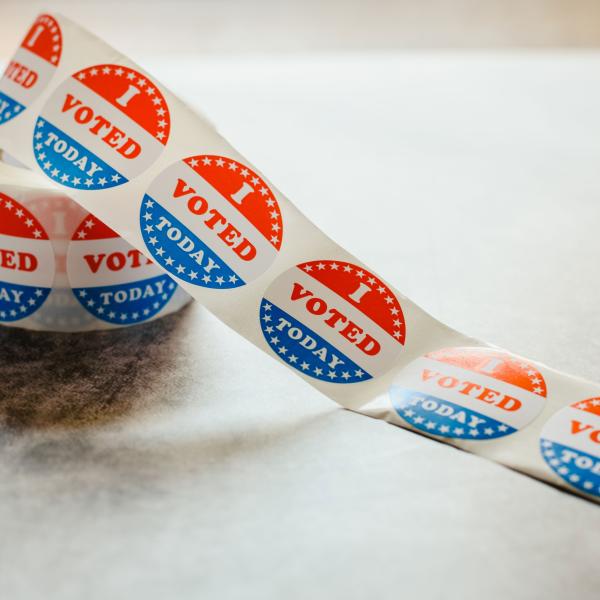 Roll of "I voted" circular stickers on a gray background for the November elections in the United States