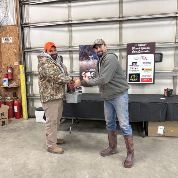 Caleb Stewart and Zach Wagner receiving a prize for most does harvested.