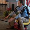 Ned Stoller of Michigan AgrAbility demonstrates a piece of adaptive equipment he created.