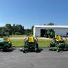 Three riding mowers.