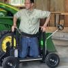 Michigan AgrAbility's Ned Stoller demonstrates a piece of adaptive equipment.