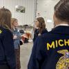KCFB Young Farmer Co-Chair Emily Kropf talks with FFA members at Kent Legislative Breakfast.