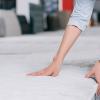 Woman checking firmness of mattress in furniture store.