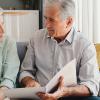 Senior couple in meeting with lawyer, planning retirement and will paperwork together in home.