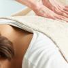 Stock image of a woman getting a back massage.